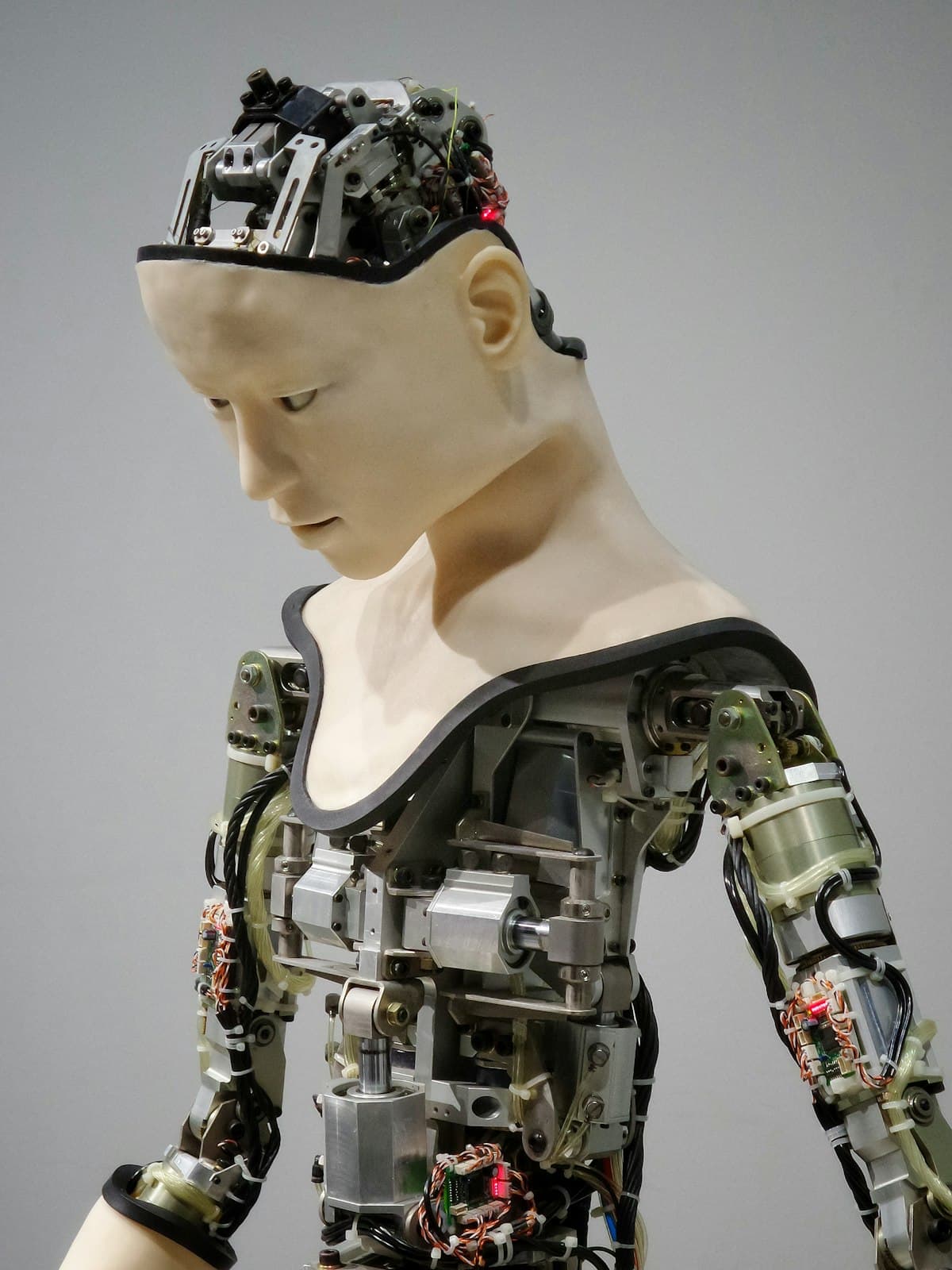 Humanoid AI robot with realistic face and exposed mechanical parts representing artificial intelligence replacing human customer support