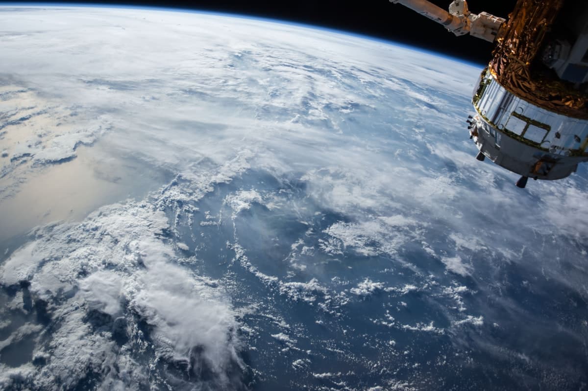 Satellites orbiting Earth with light trails, representing the Starlink constellation