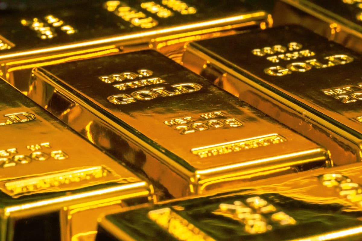 Gold bars representing Tether's massive reserves stored in a Swiss bunker