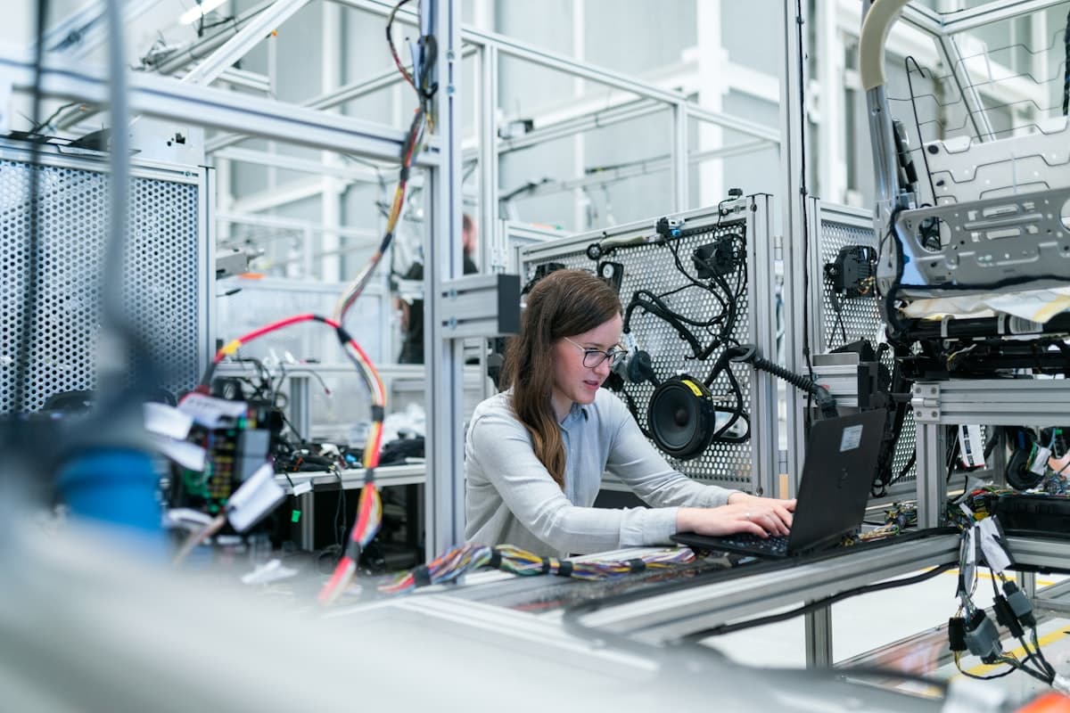 Robots working on automated assembly line in smart factory without lights